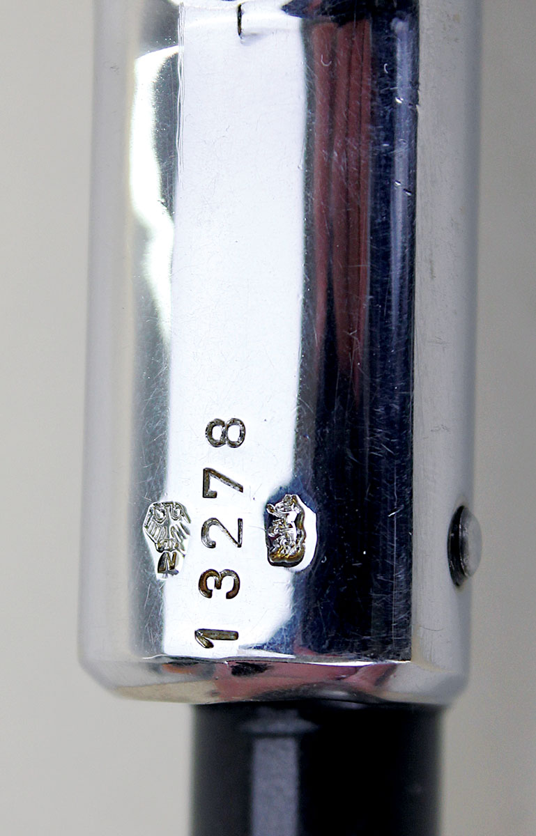Though difficult to discern, the proof mark on  the right is a bear rearing up on its hind legs, a  symbol of the Berlin proof house. The left-hand eagle-over-N stamp indicates proof for  smokeless powder rifled barrels. The stamp was used in West Germany after 1950.